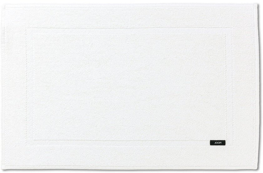Strahlendes Weiß für Ihr Bad: Der "Joop!" Badteppich/Vorleger "Pearl" aus Baumwolle in der Farbe "Weiß" bringt Helligkeit und Eleganz in Ihr Badezimmer.