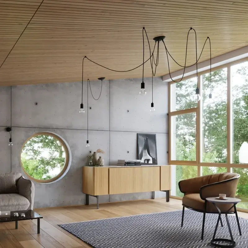 Moderne schwarze Pendelleuchte mit flexiblen Kabeln im Wohnzimmer – stilvolle Hängelampe für modernes Interieur