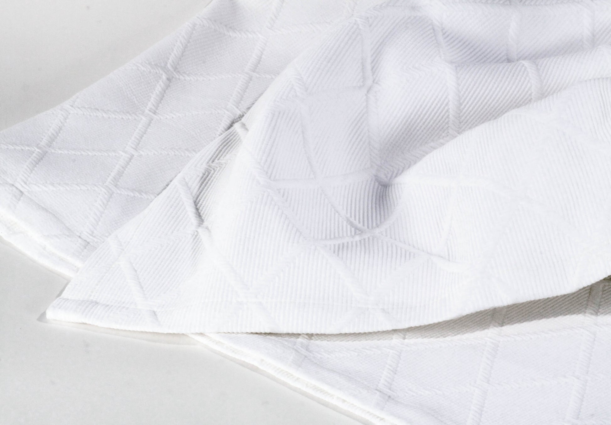 Perfekt für Ihr Doppelbett: Weiße Tagesdecke Vera mit Kissen und Rautenmuster von Evelyn Kahle: Die Tagesdecke ist die perfekte Ergänzung für Ihr Doppelbett.